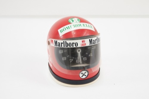 NIKI LAUDA: A small commemorative Niki Lauda helmet with Heuer analog clock inside, 12cm high [Location: Melbourne]