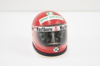 NIKI LAUDA: A small commemorative Niki Lauda helmet with Heuer analog clock inside, 12cm high [Location: Melbourne]