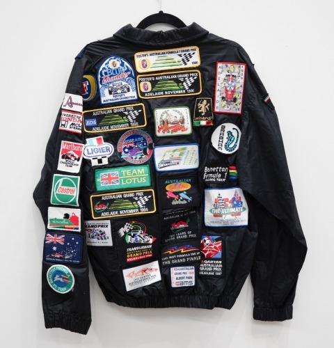 AUSTRALIAN GP: A jacket with numerous c1980s cloth patches mostly from the Australian Grand Prix in Adelaide & Melbourne, also has patches from F1 teams [Location: Melbourne]