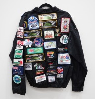 AUSTRALIAN GP: A jacket with numerous c1980s cloth patches mostly from the Australian Grand Prix in Adelaide & Melbourne, also has patches from F1 teams [Location: Melbourne]