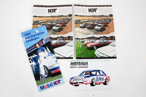 24 · HDT: A group of HDT items, including 'Group A Commodore' sticker, 1987 Mobil HDT Merchandising Catalogue, and two HDT Owners Club newsletters, Feb 1991 & August 1990