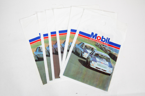 26 · HDT: Eight original unused late 1980s Mobil HDT printed bags, made to affix to the inside of the Commodore glove box and hang down, 30cm high