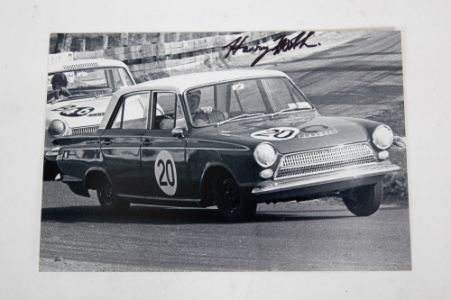 48 · HARRY FIRTH: A signed photograph featuring Harry Firth driving the #20 Ford Cortina to victory at Bathurst 500 1973, signed by Firth, 20cm high, 30cm wide
