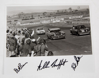 BATHURST: A signed b/w photograph featuring Allan Moffat crossing the finish line at the Bathurst 500, 1971, signed by drivers Allan Moffat, Phil Barnes & Bob Skelton, 21cm high, 26cm wide