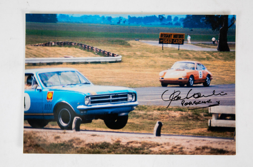 73 · ALAN HAMILTON: A signed phoiograph featuring Norm Beechey in Monaro followed by Alan Hamilton in Porsche at Symmonds Plains c1969, signed by Hamilton, 20cm high, 30cm wide