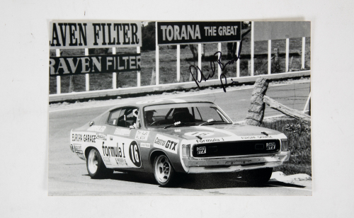 PHIL BROCK: A signed b/w photograph featuring Phil Brock driving Chrysler Charger at Bathurst 1000 c1973, signed by Brock, 20cm high, 30cm wide