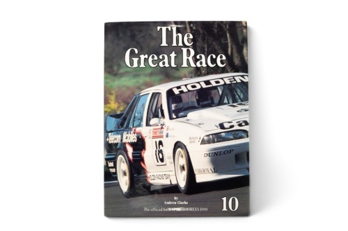 128 · THE GREAT RACE: A signed copy of 'The Great Race - Tooheys 1000 - 1990', hardcover book with inserted photo signed by winner Allan Grice, published 1991