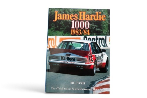 JAMES HARDIE 1000: A signed copy of 'James Hardie 1000 - 1983/84, signed by Peter Brock, Larry Perkins & John Harvey, hardcover book, 1984
