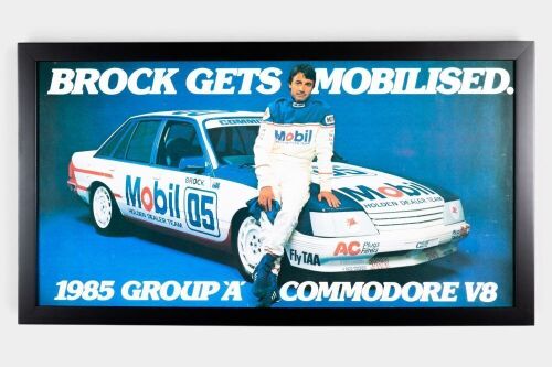 BROCK: An original advertising poster 'Brock Gets Mobilised, 1985 Group A Commodore V8', framed and glazed, measures 43.5cm high, 79cm wide