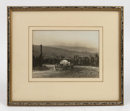 BUGATTI: An original early photograph of a Type 13 Bugatti (Registration Plate: XK 9675) believed to be taken in England, possibly Kop Hill, framed and glazed, measures 29cm high, 34cm wide overall