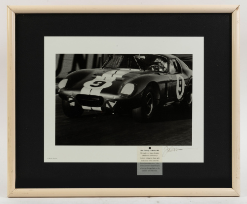 DAN GURNEY: A b/w photograph of Dan Gurney driving Shelby Cobra Daytona Coupe at Le Mans 1965, signed by the photographer, image 21cm high, 30cm wide