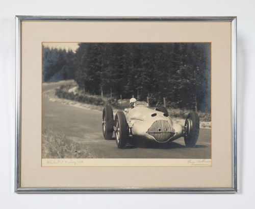 MERCEDES W125: A fine original b/w period photograph featuring Rudolf Uhlenhaut driving his Silver Arrow, signed and dated in pencil to margin by Rudolf Uhlenhaut 1938 and famed photographer George Monkhouse