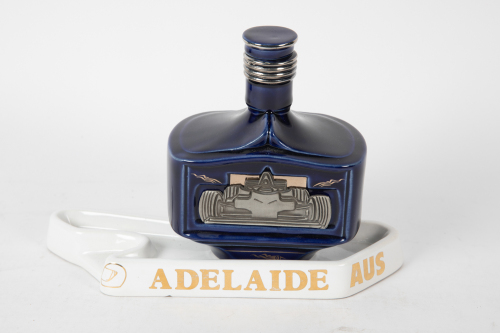 AUSTRALIAN GP: Two items to commemorate the Australian Grand Prix, includes an Adelaide racetrack ashtray, 25cm long and a 2002 Melbourne Port bottle (500ml)