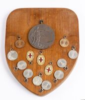 EDDIE HALL: A group of medallions awarded to famed Talbot, Bugatti, MG, Bentley driver Eddie Hall for various motoring events, one group mounted within an early brass Bugatti radiator surround [Location: Perth] - 3