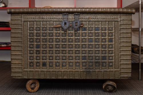 WEDDING CHEST: An impressive antique metal bound Indian wedding chest on wheels [Location: Perth]