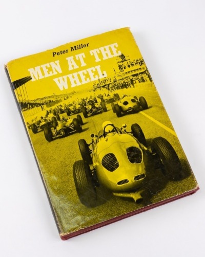 MEN AT THE WHEEL: A hardcover book by Peter Miller published by B.T.Batsford Ltd, inscribed and signed by various motor racing drivers and personalities including World Champions Graham Hill, Jack Brabham, Phil Hill and many others [Location: Perth]