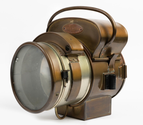 HEADLIGHT: A Ducellier (France) brass No.2478 headlamp, lens width 16.5cm (6.5 inches), mounting bracket width approx. 22cm, overall height 32cm