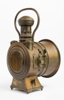 HEADLIGHT: A c1900 large 'The Polkey' (UK) brass headlight, design No. 401472, convex lens width 18.4cm (7 1/4 inches), 45cm high overall [Location: Melbourne] - 2