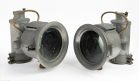 HEADLAMPS: Two large cast aluminum ECL branded headlamps, lens width 16.5cm, height to handle top 30cm, unit length 33cm [Location: Melbourne]