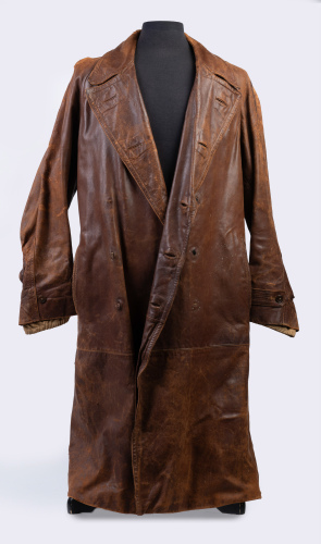 DUSTER COAT: A long vintage brown leather duster coat with distressed finish, made by Selfridge of London, 135cm long