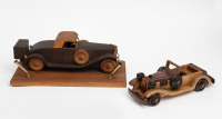MODELS: Two wooden classic car models, largest on timber base with two pen holders, largest 33cm long [Location: Melbourne]