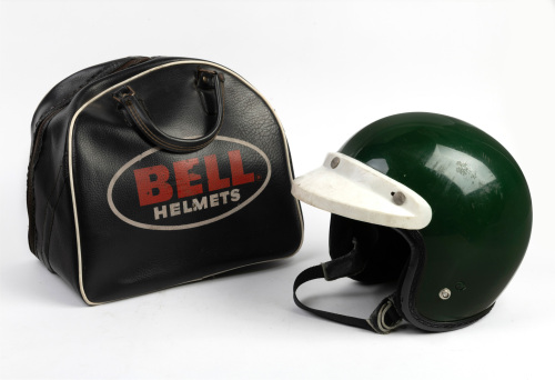 HELMET: An Arai S-70 open face helmet in green with white peak in c1960s Bell Helmets vinyl bag