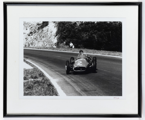 MASERATI: A b/w photograph of c1957 Maserati 250F doing powerslide move, driver thought to be Fangio, limited edition (205/250), image 31cm high, 41cm wide