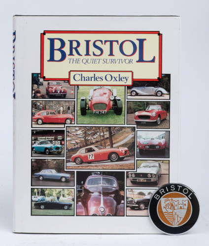 BRISTOL: Two items relating to Bristol cars, includes 'Bristol - The Quiet Survivor' by Charles Oxley, hardcover book, 1988 and a Bristol 2 Litre metal & enamel badge, 6cm wide