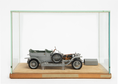 ROLLS-ROYCE: A metal, possibly kit form Rolls-Royce Silver Ghost model, 19cm long, in glass display case