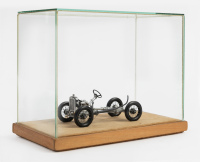 AUSTIN: An Austin Seven rolling chassis model, 10.5cm long, in glass display case [Location: Melbourne]