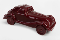 MORGAN: A maroon ceramic classic car coin bank in the style of a Morgan by Janet Hill Ventures (UK), 23cm long [Location: Melbourne]