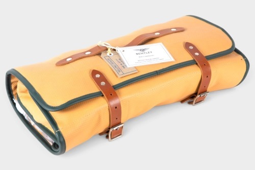 TOOL ROLL: A high-quality perforated Bentley tan leather tool roll, made in Sheffield, England. Once extended, measures 90cm high, 50cm wide [Location: Melbourne]