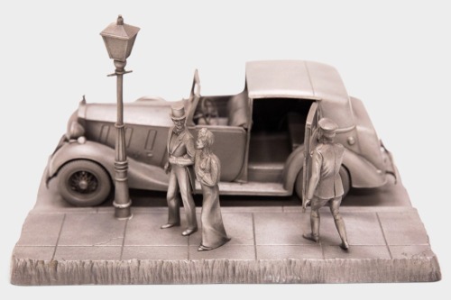 PHANTOM III: A pewter desk piece model by Raymond Meyers/Franklin Mint of the 1937 Rolls Royce Phantom III in a street setting, 21cm long, 13.5cm wide, 13cm high [Location: Melbourne]
