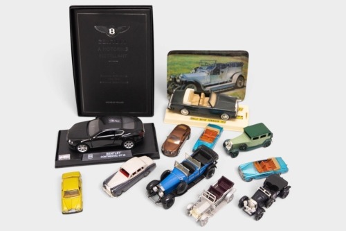 MODELS: A group of various scale Rolls-Royce and Bentley model cars, mostly 1:64-1:43 scale, along with a tray with a Rolls-Royce silver ghost image and a copy of 'Bentley A Motoring Miscellany' book by Nicholas Foulkes [Location: Melbourne]