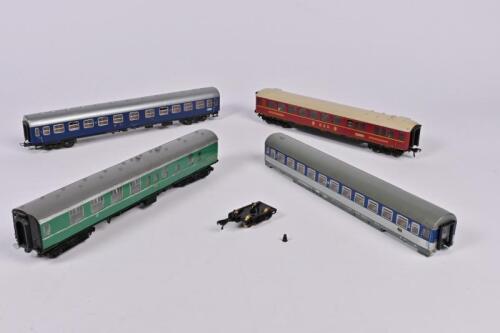 FLEISCHMANN: Four Fleischmann DB coaches including one restaurant car 'DSG Speisewagon' with lighting accessory, blue/silver coach with 'Touropa', silver/blue coach with loose bogie and green passenger brake without couplers&nbsp;and some retouching
