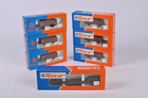 ROCO: Six Roco 46043 open goods wagons and a 48990 bogie well wagon, all mint boxed