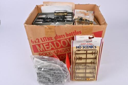 SPARE PARTS: A large quantity of spare parts including loco motors, couplings, light poles, containers, rolling stock accessories, Hornby pier sets, telegraph poles etc..