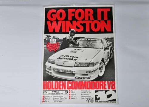 COMMODORE V8 (WIN PERCY): A large Holden Motor Sport poster depicting Win Percy with a Holden Commodore V8. Circa 1990's (127cm high x 90.5cm wide)