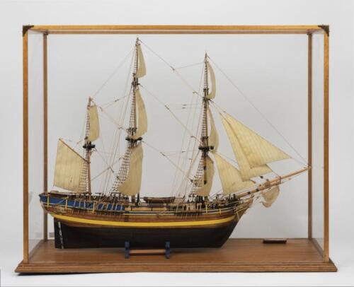HMS BOUNTY: A fine English made timber scale model of the HMS Bounty in display case (case 67cm high x 87cm wide)