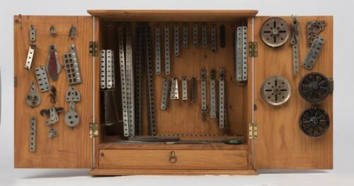 MECCANO: A pinewood cabinet containing early nickel No.5 set, circa 1922/23