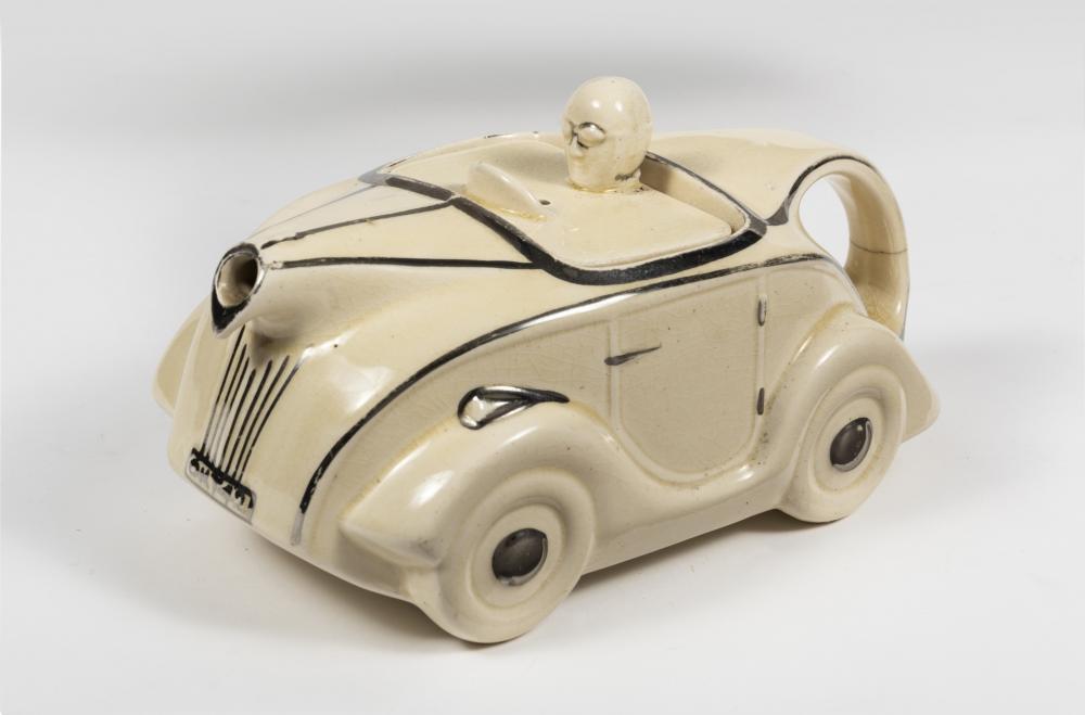 TEAPOT: A novelty porcelain car form teapot. Measures 10 cm H, 22 cm W