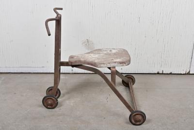 TRIYCLE: A 1940s rustic child's tricycle with a timber seat and twin front wheels