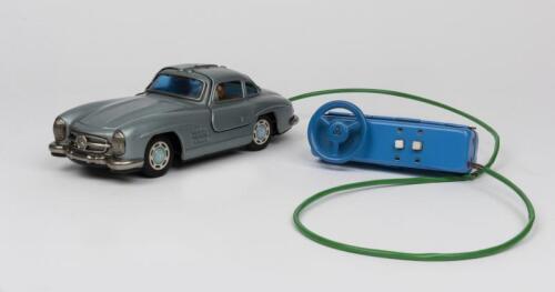 MERCEDES: A 1950s Japanese R/C battery operated tin toy of a Mercedes Benz Gullwing 300 SL 2-door coupe by Bandai