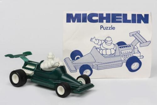 MICHELIN: A Bibendum puzzle of a Grand Prix car and paper sign (green)