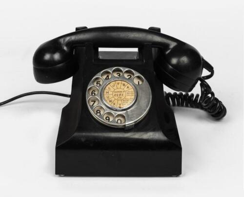 TELEPHONES: An STC black Bakelite rotary telephone, circa 1960