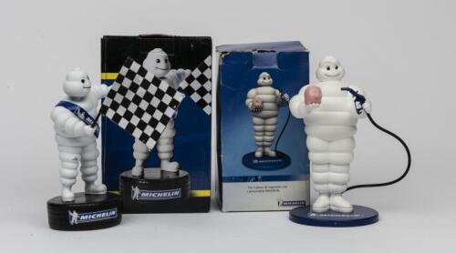 MICHELIN: A Bibendum "bobblehead" figure and a Bibendum figure holding a piggy bank and fuel hose