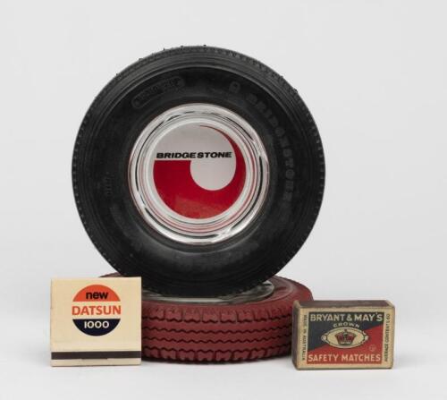 BRIDGESTONE: Two promotional ashtrays in the form of a tyre with glass insert 16cm diameter, together with two original boxes of matches by Bryant and May 'Datsun 1000'.