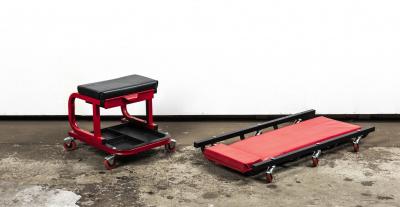 WORKSHOP EQUIPMENT: Two padded workshop trollies in the form of seat and flat rolling bed