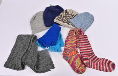 WARMERS: A collection of unworn hand knitted apparel including a scarf, socks, fingerless gloves and two beanies , together with two commercially produced beanies