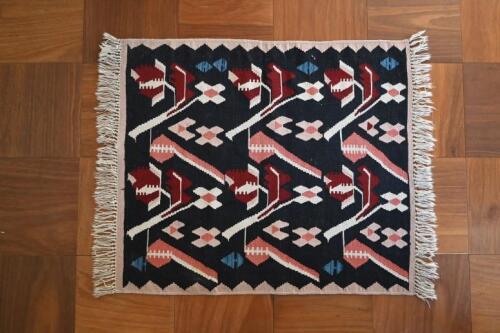 RUGS: A handwoven native American black ground wool rug, West Coast, USA<br />120 x 104cm